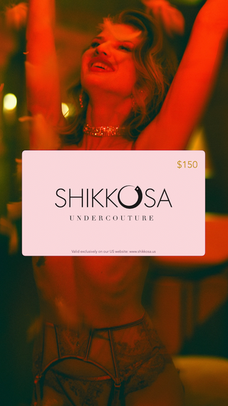Shikkosa Undercouture gift card held by a person in a red-lit setting