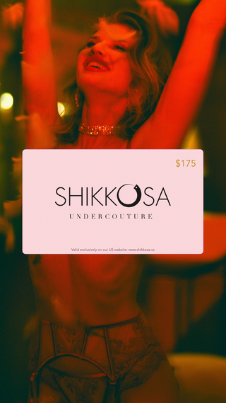 Woman holding a Shikkosa Undercouture gift card with a blurred background