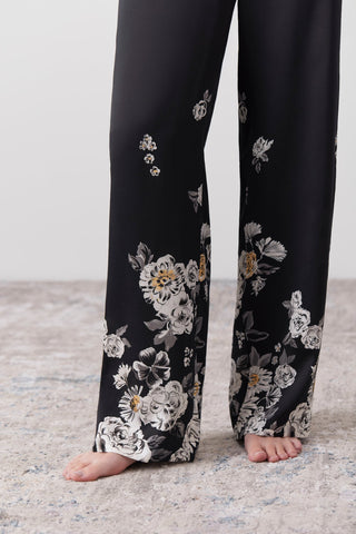 Detail of a woman wearing long silk pants printed by hand