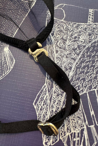 Close-up of a golden accessory details, with logo SHIKKOSA