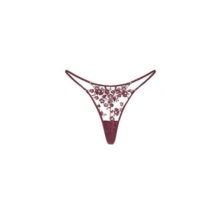 A pair of Shikkosa women's lingerie lace thong in plum color, featuring a floral lace pattern on the front and sides with a solid plum waistband and leg openings, displayed on a clean white background.