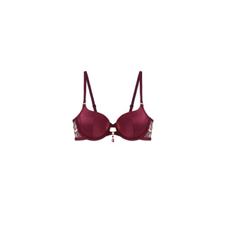 A structured underwire bra in deep burgundy with decorative gold lace detailing on the outer cups and a small dangling charm at the center, shown against a plain white background.