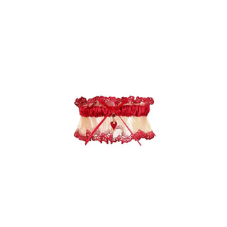 Red and beige lace garter belt with a red heart charm, photographed on a solid white background.