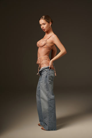 Female Lingerie model wearing jeans and lingerie on a dark background - Shikkosa Lingerie