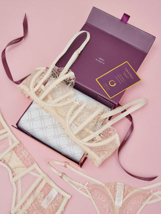 SHIKKOSA Lace lingerie set with a purple LUXURY GIFT box on a pink background